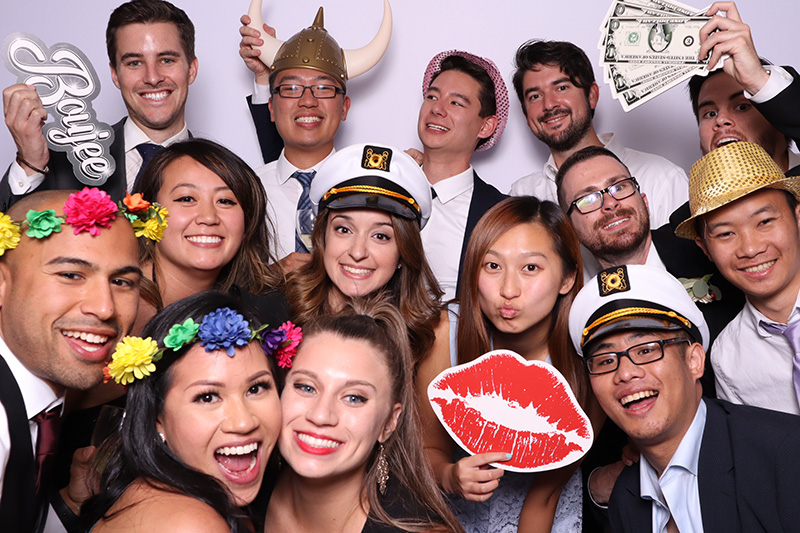 Group enjoying San Francisco photo booth with props, showcasing customizable photo booth options for event entertainment.